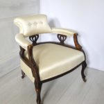 Edwardian salon tub chair upholstered in a satin oyster damask, side view.