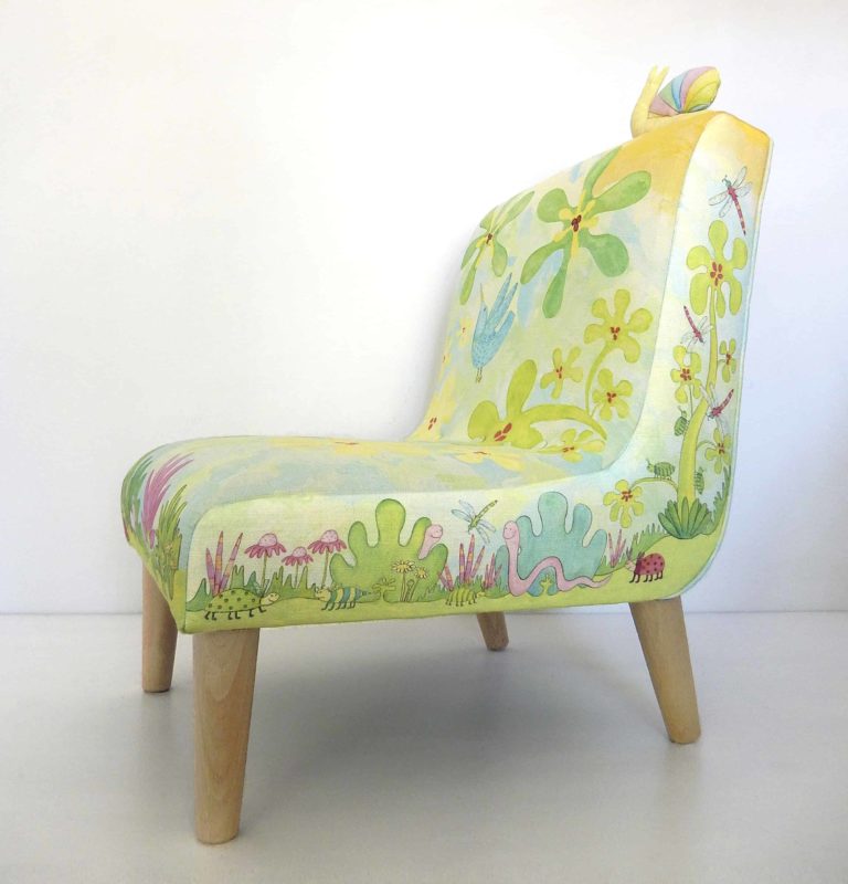 Little chair with printed fabric of cute animals, bugs, birds, leaves, flowers in blues and greens.