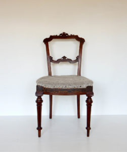 A traditionally upholstered walnut Victorian side chair.