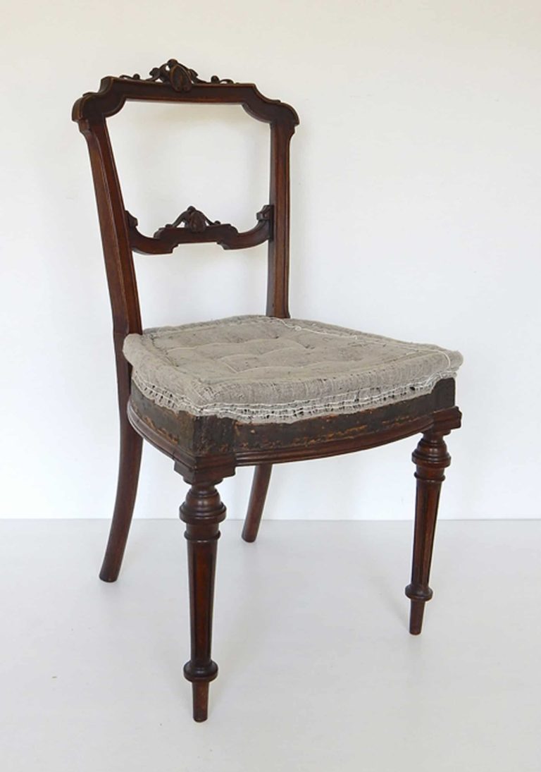 A traditionally upholstered walnut Victorian side chair.