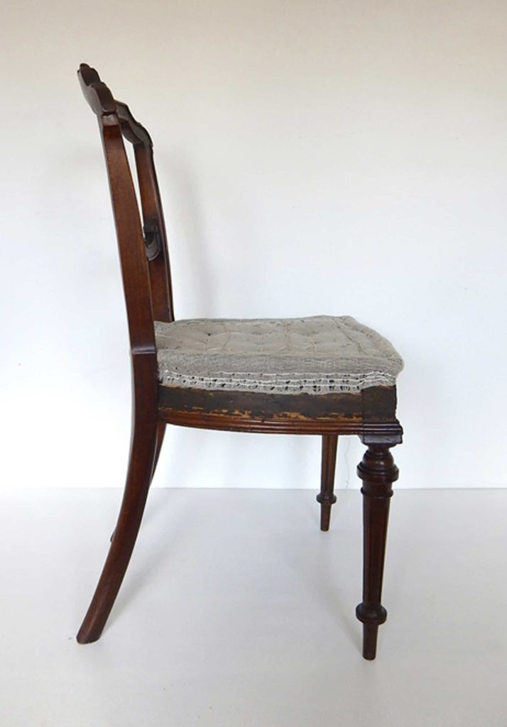 A traditionally upholstered walnut Victorian side chair.