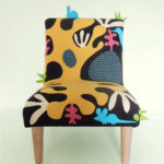 Child’s chair, handmade wool appliqué fabric decorated with abstract shapes and animals.