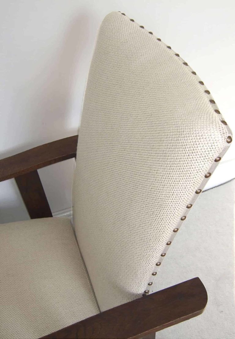 Arts and Crafts oak reclining armchair; detail of basket weave fabric.