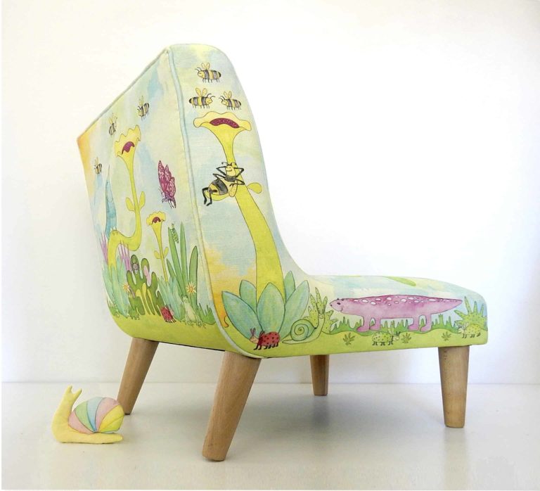 Little chair with printed fabric of cute animals, bugs, birds, leaves, flowers in blues and greens.