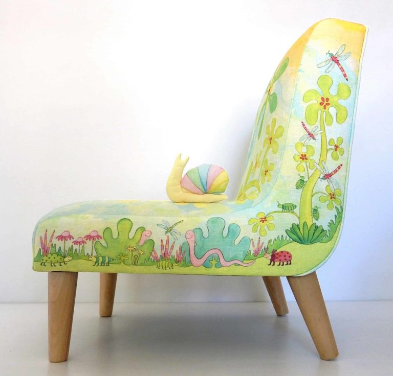 Little chair with printed fabric of cute animals, bugs, birds, leaves, flowers in blues and greens.