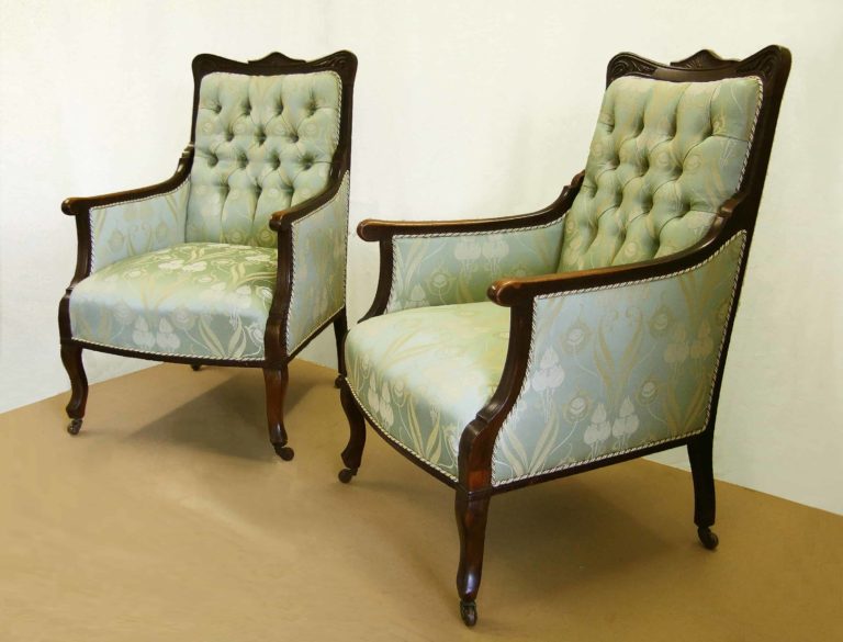 Pair of Edwardian library armchairs, newly upholstered in green and gold damask fabric.