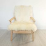 A vintage Parker Knoll armchair; sheepskin seat and goat hair on hide to back.