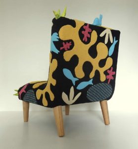 Child’s chair, handmade wool appliqué fabric decorated with abstract shapes and animals.