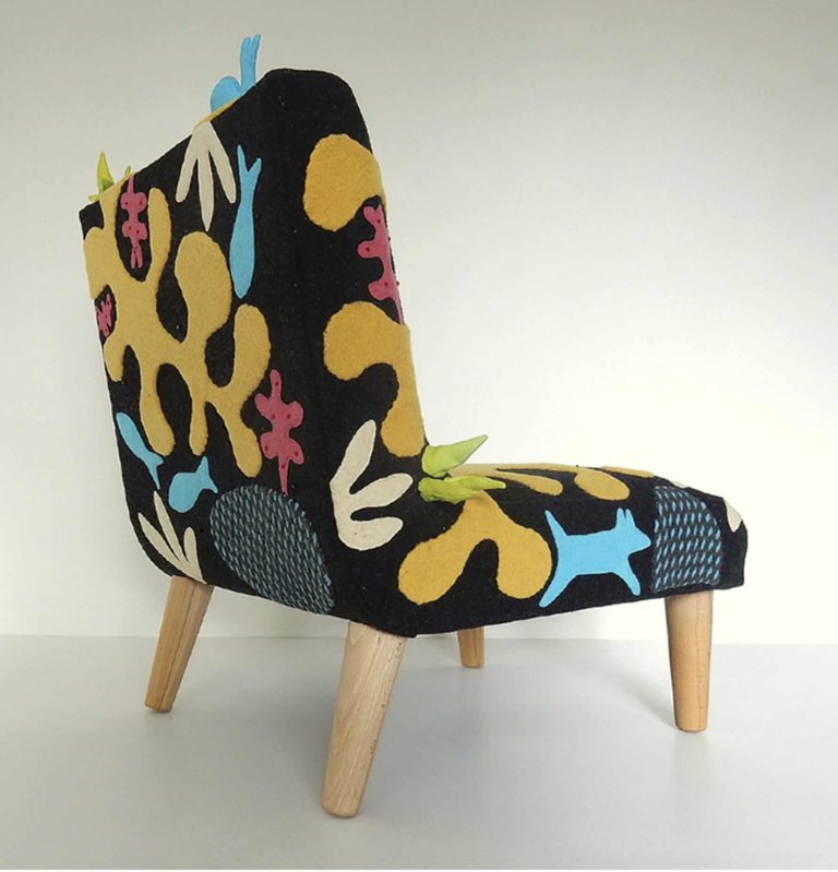 Child’s chair, handmade wool appliqué fabric decorated with abstract shapes and animals.