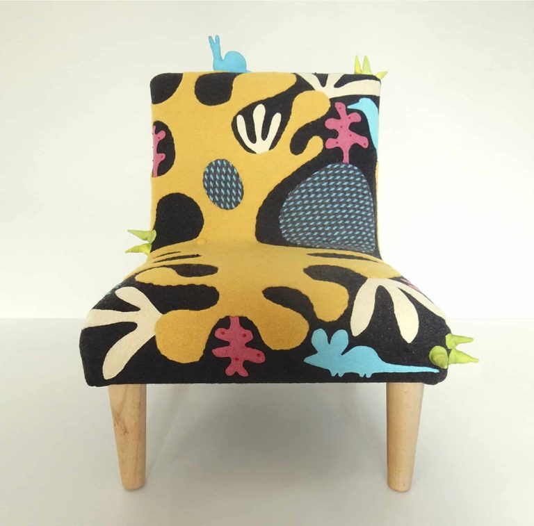 Child’s chair, handmade wool appliqué fabric decorated with abstract shapes and animals.