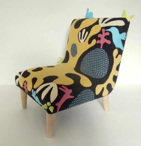 Child’s chair, handmade wool appliqué fabric decorated with abstract shapes and animals.