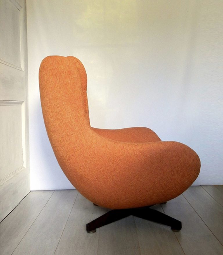 1970s retro G-Plan swivel chair; newly upholstered in orange fabric - side view.