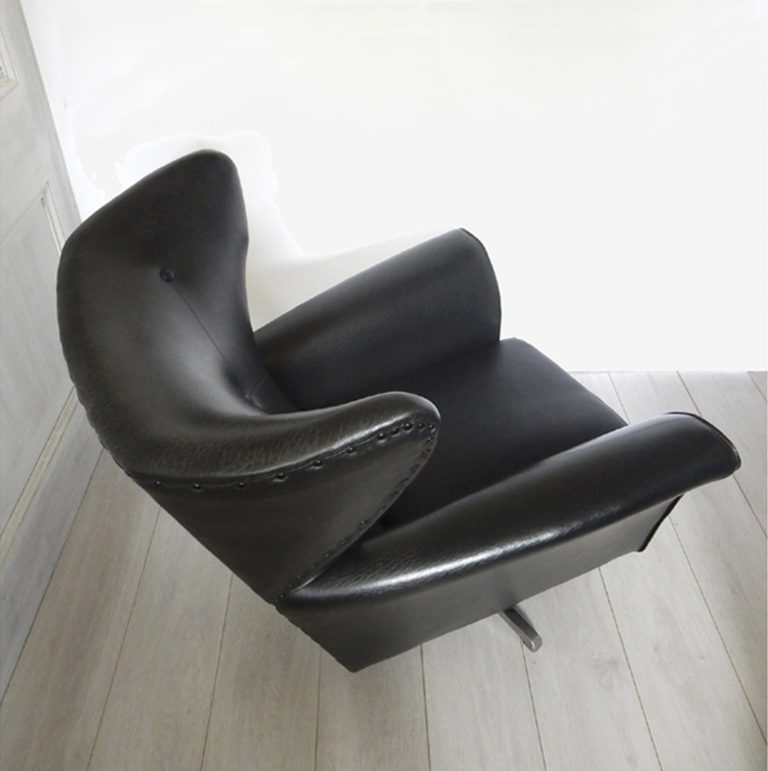 A vintage 1960s-70 swivel armchair in black vinyl fabric; top view.