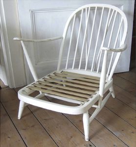 A classic Ercol 203 armchair: charcoal black wool cushions and sheepskin.