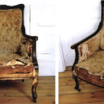 Old Edwardian library armchairs with faded and worn fabric.