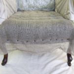 Edwardian chair upholstery - stitching down first seat stuffing.