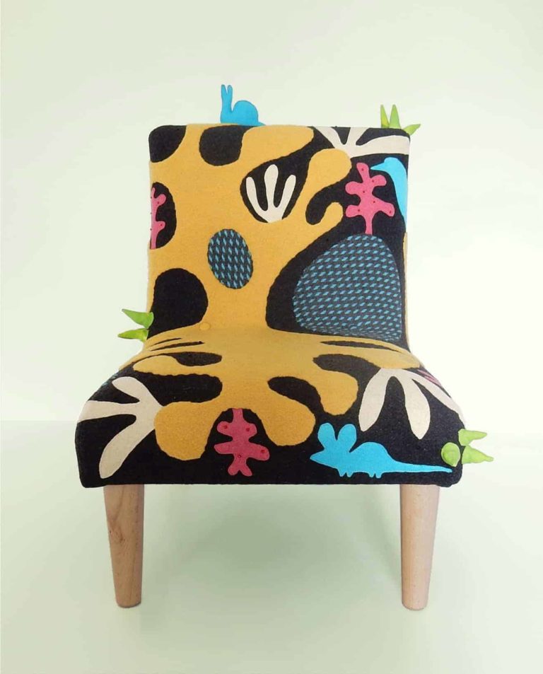 Child’s chair, handmade wool appliqué fabric decorated with abstract shapes and animals.