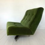 Newly upholstered retro swivel chair in forest green velvet by Designer’s Guild, side view.