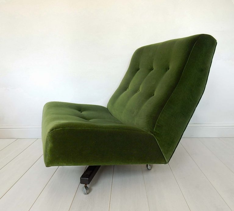 Newly upholstered retro swivel chair in forest green velvet by Designer’s Guild, side view.