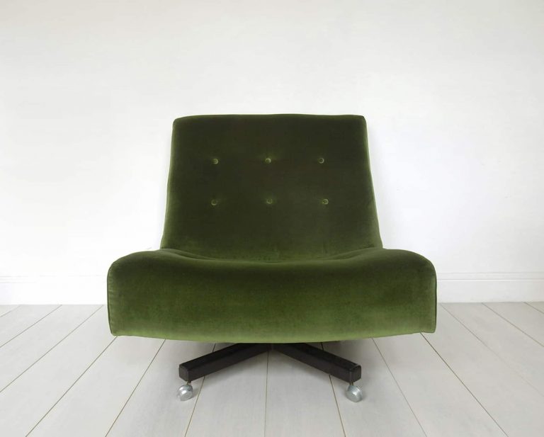 Newly upholstered retro swivel chair in forest green velvet by Designer’s Guild, front view.