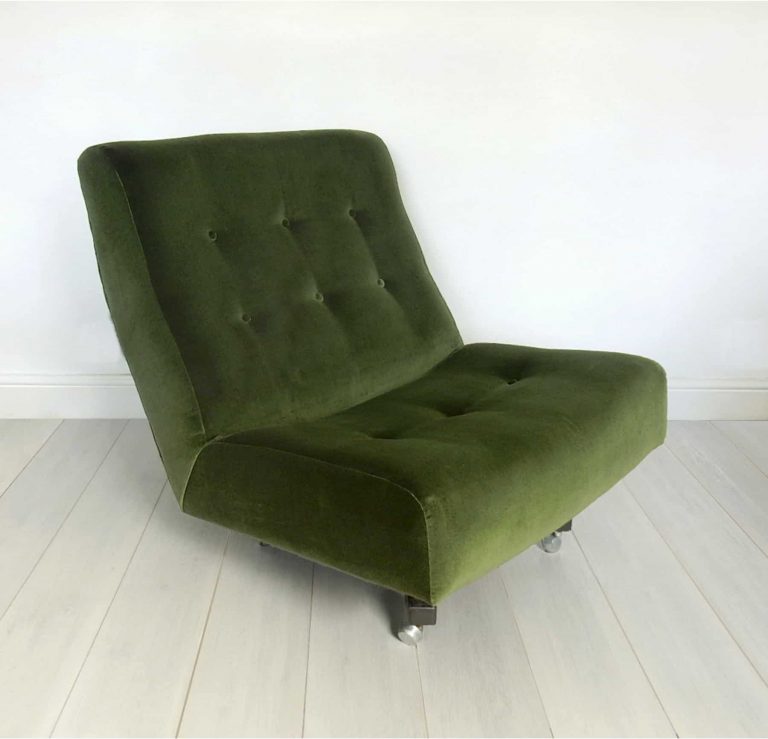 Newly upholstered retro swivel chair in forest green velvet by Designer’s Guild, side view.