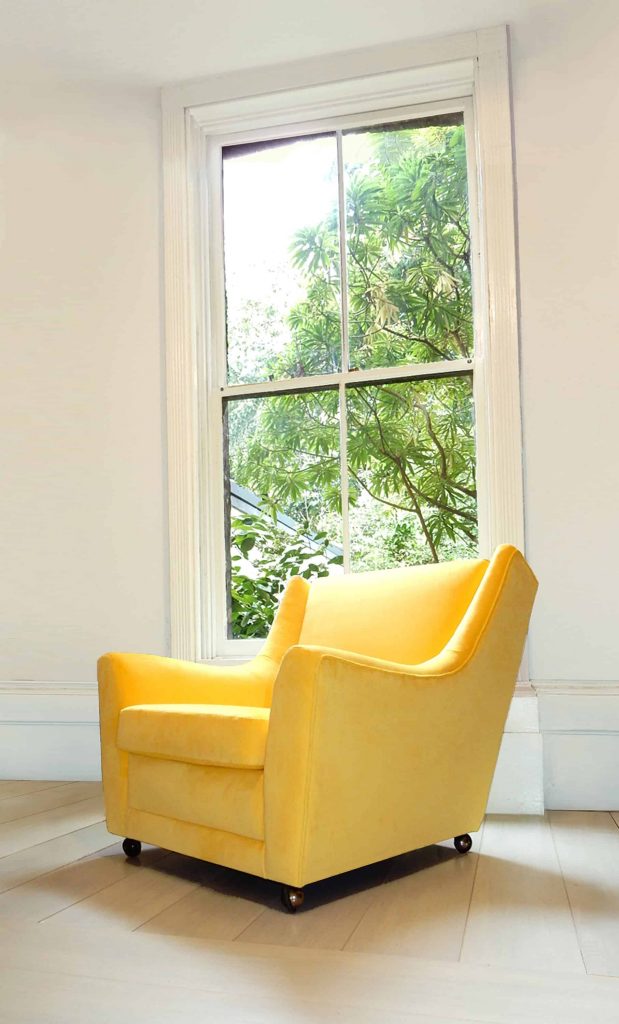 vintage G-Plan armchair newly upholstered in bright yellow velvet fabric.